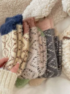 Cozy fluffy coral fleece socks detail view, soft thermal winter sleep socks close-up.