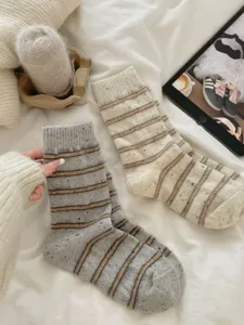 Detailed view of women's autumn winter thick warm wool striped mid-tube socks with cozy speckles.