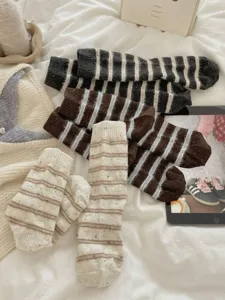 Cozy woolen knit striped socks detail shot, soft texture and warm winter thermal design.