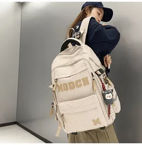 Detailed view of large capacity beige plaid school backpack with stylish letter prints.