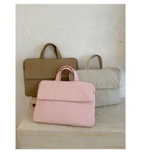 Padded laptop bag detail, solid color waterproof handbag, spring commuting file tote bag.