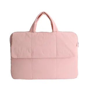 Detailed view of the pink quilted laptop bag, showing fine stitching and soft fabric texture.