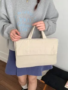 Beige quilted laptop bag with double handles, thick padded sleeve for daily commute use.