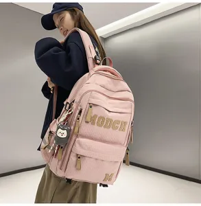 Detail view of the pink grid student backpack with cute animal charm and spacious compartments.
