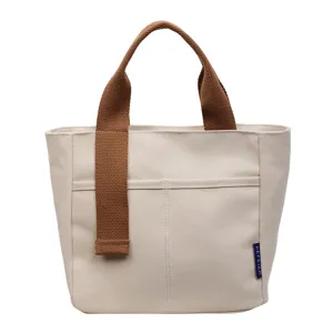 Borsa a mano in tela con manici marroni, dettaglio borsa secchiello casual, stile tinta unita.