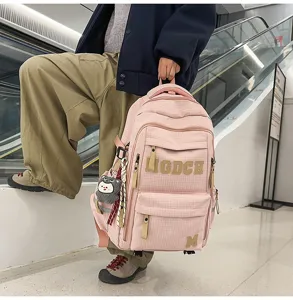 Fashionable pink grid school backpack with large capacity, cute letters and pendant detail.