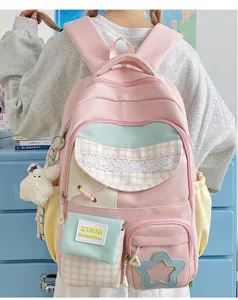 Detailed view of the cute pink pastel color block school backpack with multi pockets and charm.