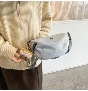 Detailed view of casual nylon chest sling bag with cute plush pendant for daily wear.