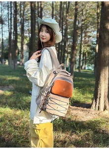 Outdoor detail shot showing the spacious color block backpack with front bungee cord design.