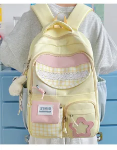 Cute Japanese candy color multi-pocket school backpack detail shot with plush doll and lace.