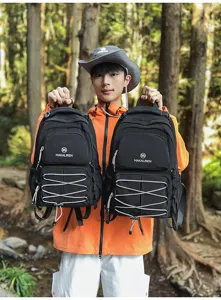Large capacity black backpack for student travel mountaineering with front straps and multiple pockets.