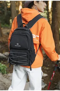 Outdoor hiking detail view of the black college style canvas backpack with drawstring.