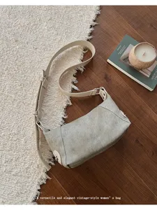 Detail shot of a trendy canvas underarm shoulder bag in versatile style for daily wear.