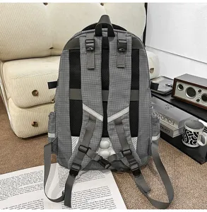 Grey grid student backpack detail showcasing adjustable double straps and breathable back design.