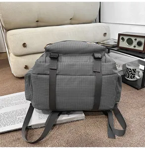 Grey grid backpack large capacity school bag student bookbag for daily use and travel.