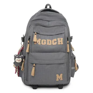 Grey grid student backpack detail view, featuring beige leather letter patches and zipper pulls.