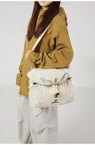 Casual streetwear shoulder bag with mesh pockets and drawstring for daily commute and travel.