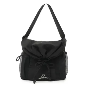 Detailed view of the black utility crossbody bag with drawstring and mesh pockets.