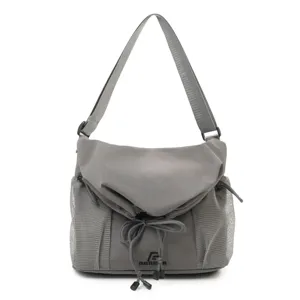 Detailed view of grey tactical messenger bag showing mesh side pockets and drawstring closure.