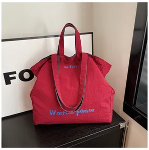 Grande borsa shopper casual in tela per donne con cinghie a doppio uso e ricamo blu.