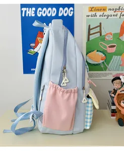 Detailed side view of light blue sweet candy color school backpack with cute pink pocket.