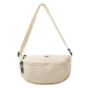 Detail view of the casual canvas crescent sling bag, featuring smooth black zippers and strap.