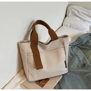 Borsa a mano minimalista casual in tela da donna, elegante shopper con manici marroni.