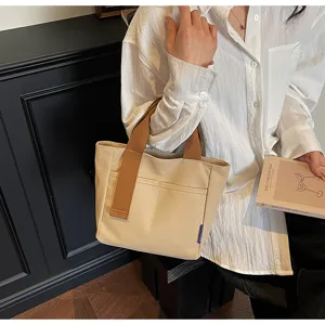 Borsa shopper in tela minimalista casual da donna, beige con manici e tasca marroni.