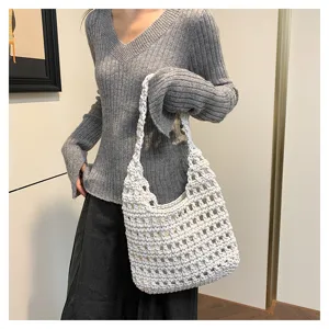 Vista dettagliata della borsa a spalla in maglia traforata bianca, stile casual chic.