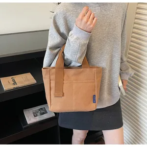 Borsa shopper in tela minimalista casual da donna, elegante borsa a mano marrone con tasca frontale.