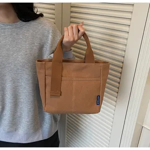 Vista dettagliata della borsa in tela casual, semplice borsa tote giornaliera con tasca frontale.