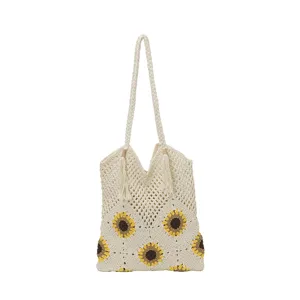 Sac cabas en crochet avec joli motif de tournesol et bretelles tressées pour usage quotidien.