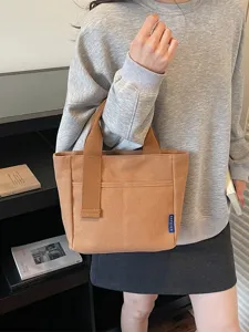 Borsa a mano minimalista e casual da donna in tela, shopper elegante con manici e comoda tasca.