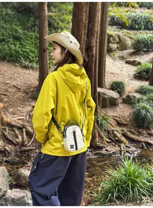 Outdoor mini shoulder crossbody bag lifestyle detail shot in forest, perfect for travel phone.