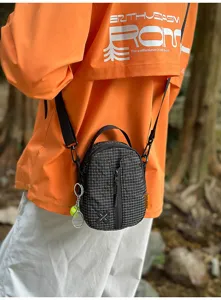 Trendy grid mini crossbody phone bag, detailed view featuring zipper closure and strap.