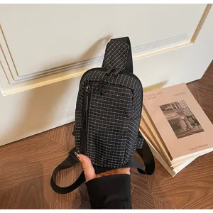 Black and white grid canvas sling bag stylish crossbody chest pack for women daily travel.