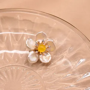 Detailaufnahme der Barockperlen-Blumenbrosche mit einzigartigen Blütenblättern und funkelndem Stein.
