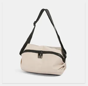 Detailed view of the lightweight nylon crossbody chest bag, showing smooth black zippers and durable strap.