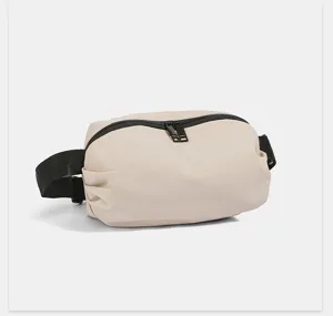 Close-up detail of the lightweight nylon fanny pack zipper and black adjustable strap.