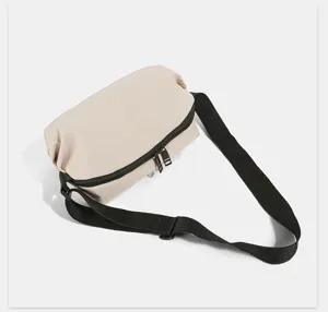 Detailed view of the lightweight nylon women's crossbody bag with black strap and zipper.