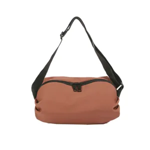 Close-up detail of the brown nylon crossbody bag featuring a durable black zipper and adjustable strap.