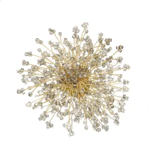Stunning starburst brooch crafted with golden wire and clear crystal beads for elegant style.