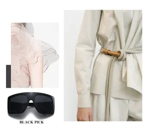 Detailed view of oversized shield sunglasses and fashion apparel styling with rope belt.