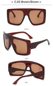 Oversized flat top sunglasses detail view, stylish brown gradient lenses with bold frame.