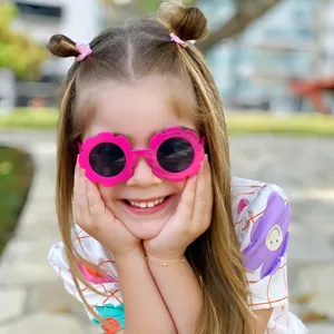 Cute kids flower sunglasses with jelly pink frame and PC lenses for trendy babies.