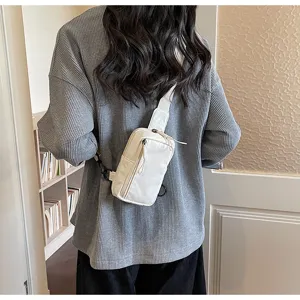 Casual white canvas crossbody sling chest bag for women, perfect for travel and daily wear.