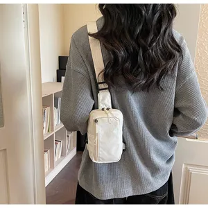 Detail shot of a minimalist white sling bag worn on back, perfect for travel and casual daily use.