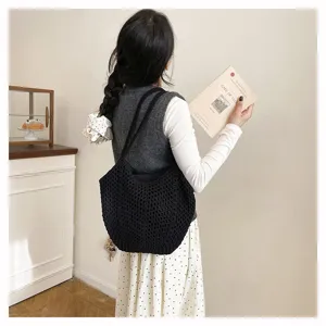 Detailansicht einer stylischen schwarzen geflochtenen Damen Schultertasche Beuteltasche.