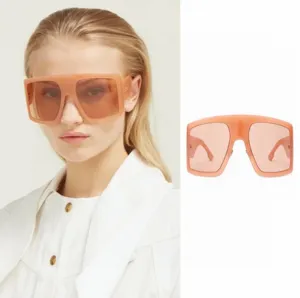 Oversized square frame sunglasses for men and women, trendy peach translucent shield eyewear.