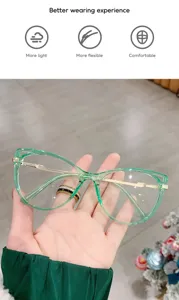 Detail view of green cat eye TR metal frame anti-blue light glasses held in hand.